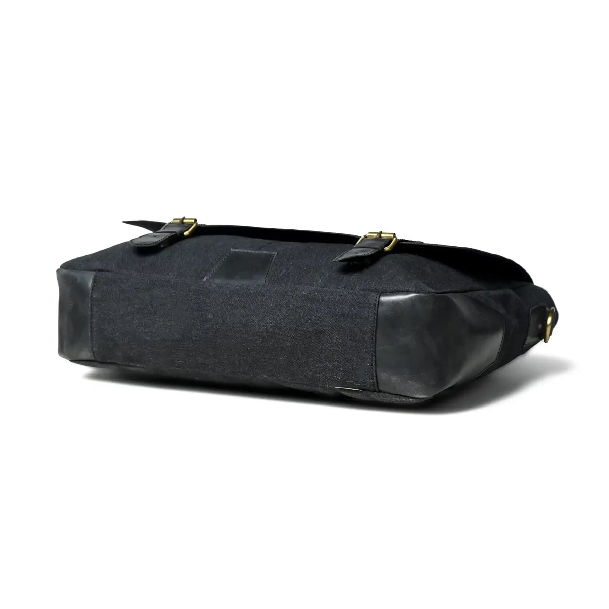 Side profile of the black leather and canvas office bag