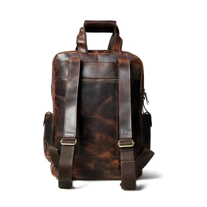 Back of the distressed leather backpack showing padded adjustable shoulder straps