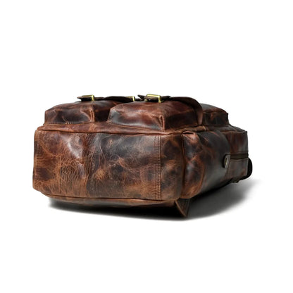 Top-down view of the distressed leather backpack showing the outer pocket layout