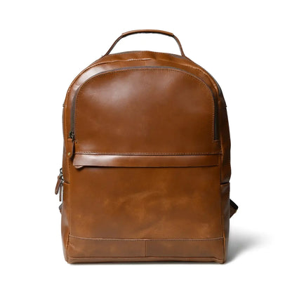 Front view of the cognac leather backpack showing the full-width zip pocket
