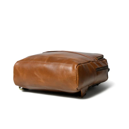 Side profile of the cognac leather commuter backpack