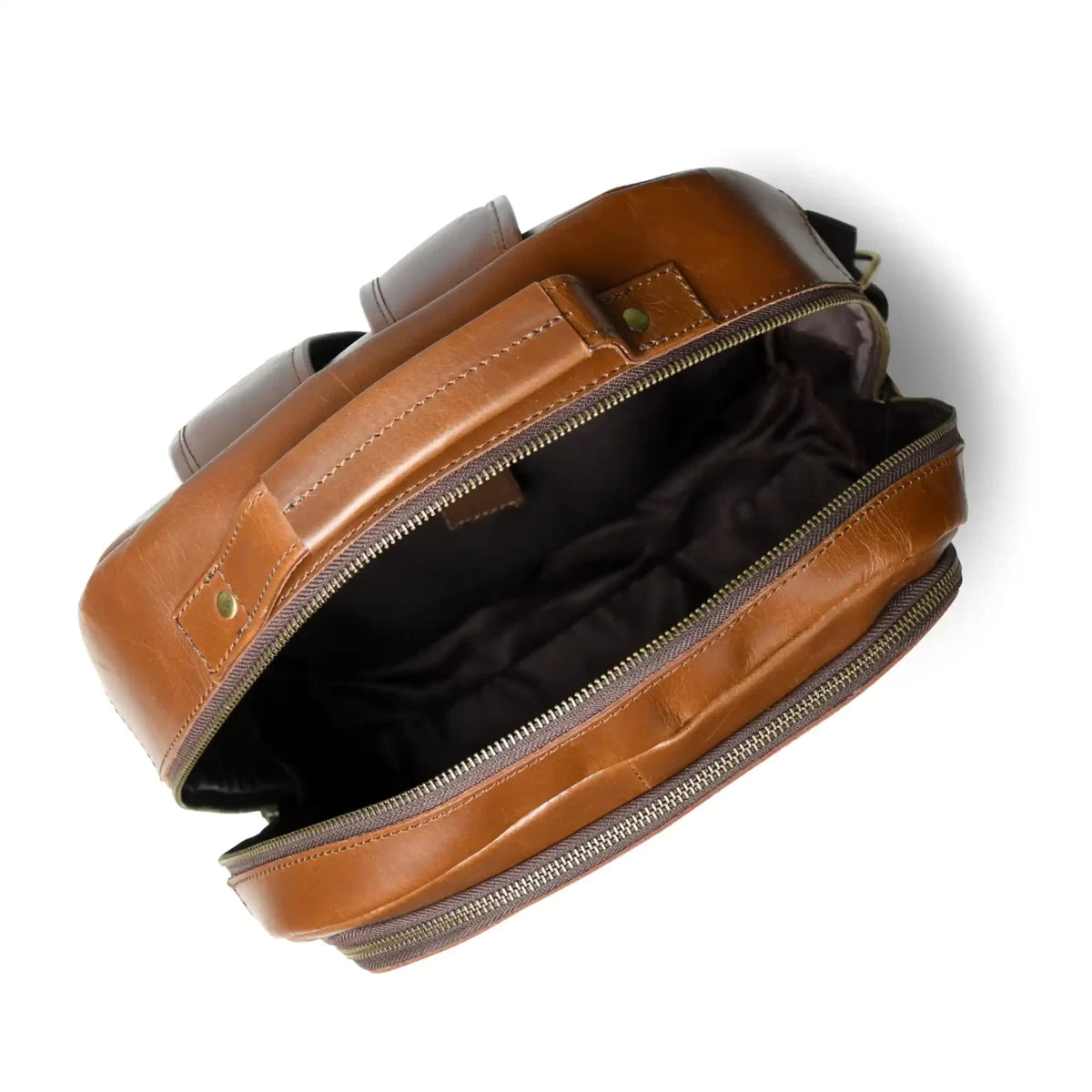 Open cognac leather backpack showing the lined main compartment