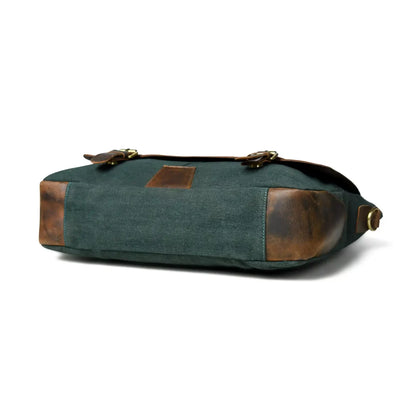 Side profile of the green canvas office bag showing the leather base corners