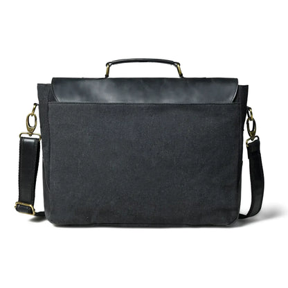 Back panel of the black canvas office bag showing the zip pocket and shoulder strap